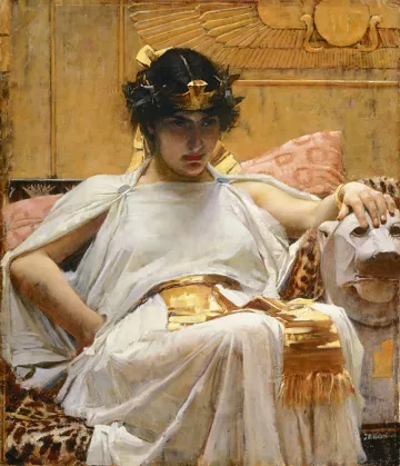 L'image représente une femme assise sur un siège orné, drapée dans une tunique blanche et une écharpe dorée. Elle porte une couronne et a les cheveux sombres, avec un regard pensif et sérieux. À côté d'elle, on aperçoit un lion stylisé sur le siège. L'arrière-plan est décoré de motifs égyptiens, avec des couleurs chaudes et une ambiance luxueuse. La composition évoque une atmosphère royale et mystique.
